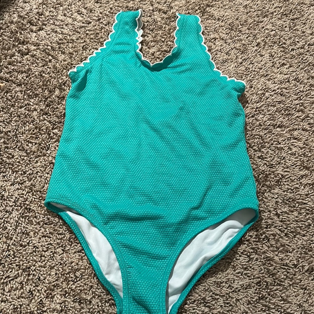 New girls swimsuit without the tags but sanitary lining.  Cute scallop detail.